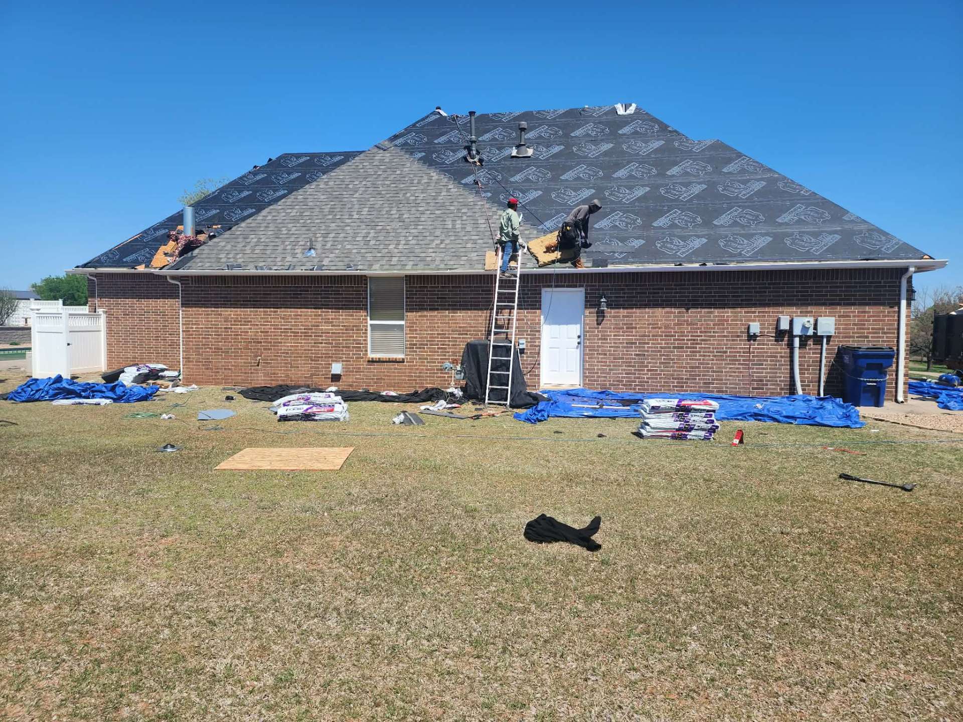 Underlayment installed and crew laying new shingles