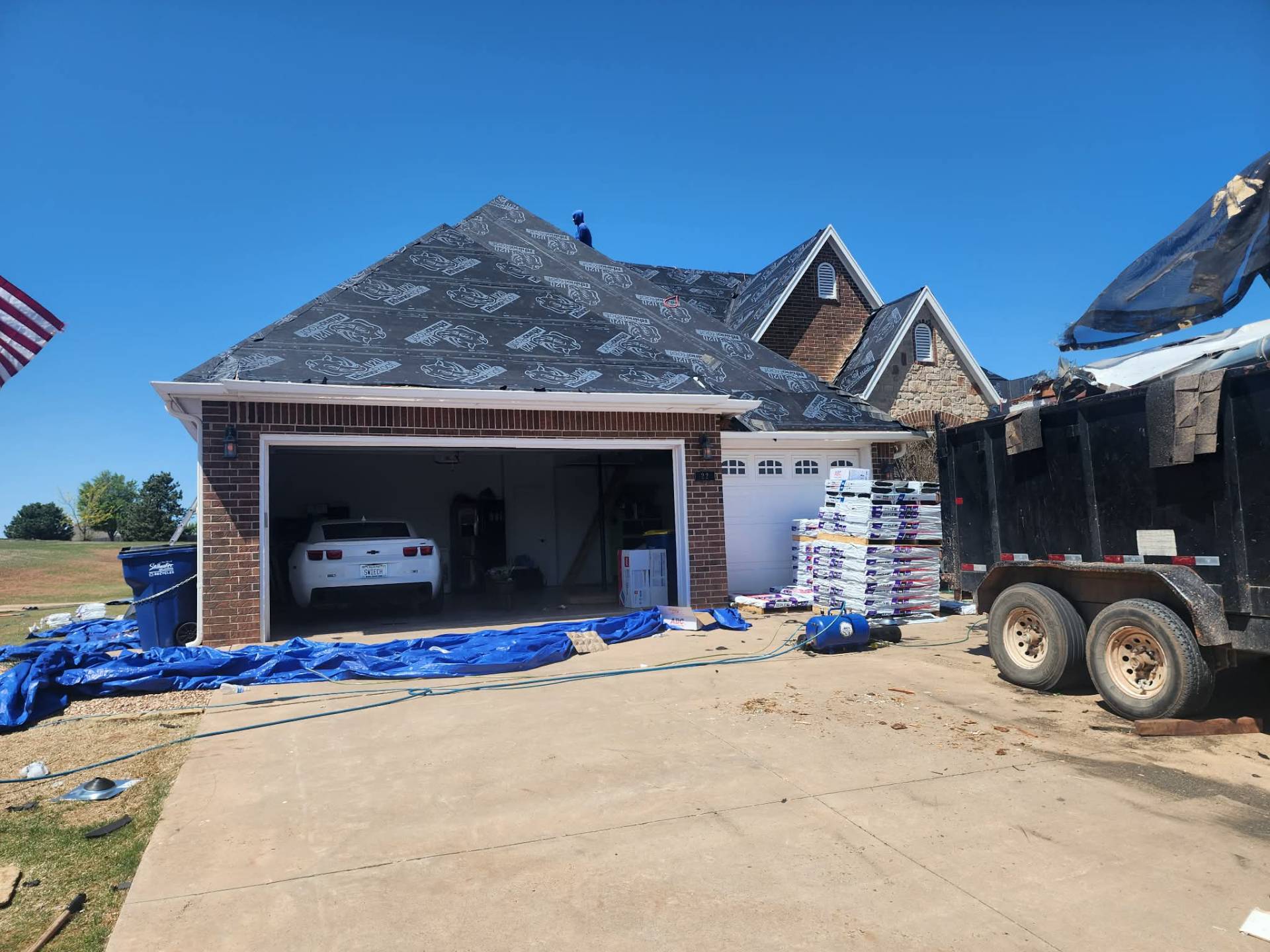 Synthetic underlayment with materials staged in driveway