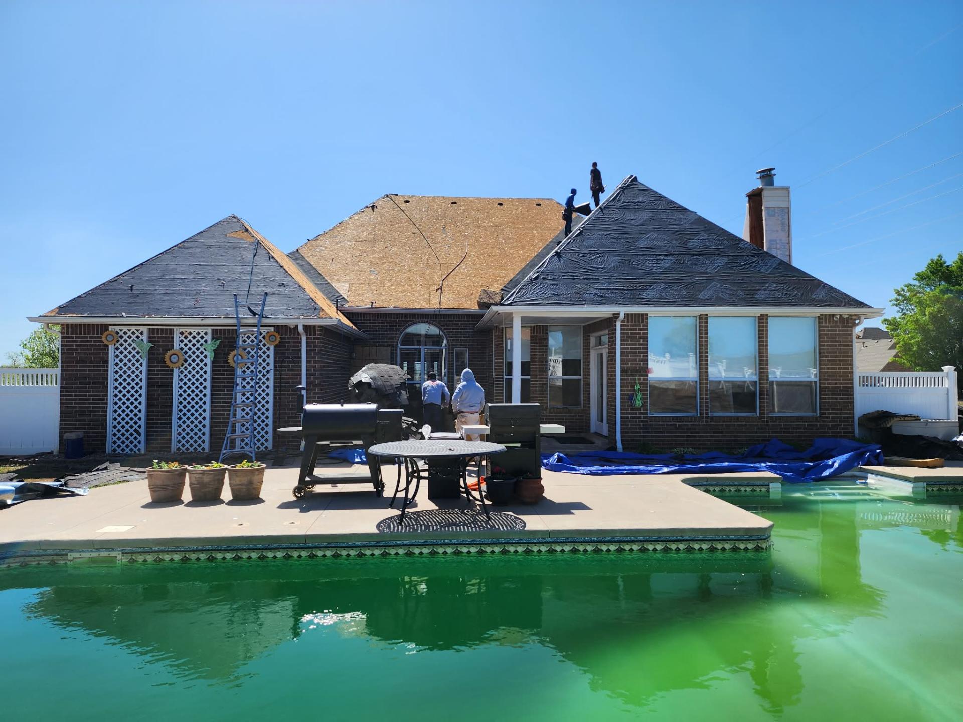 Decking and underlayment progress — backyard view by pool