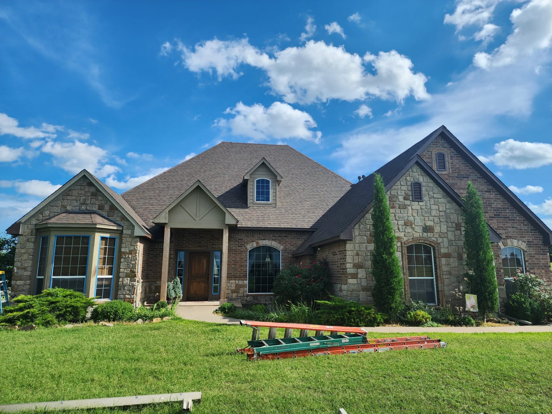 Finished roof on stone-front Oklahoma home
